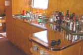 Photo of golden kitchen cabinetry in restored 1948 Spartan Manor Trailer